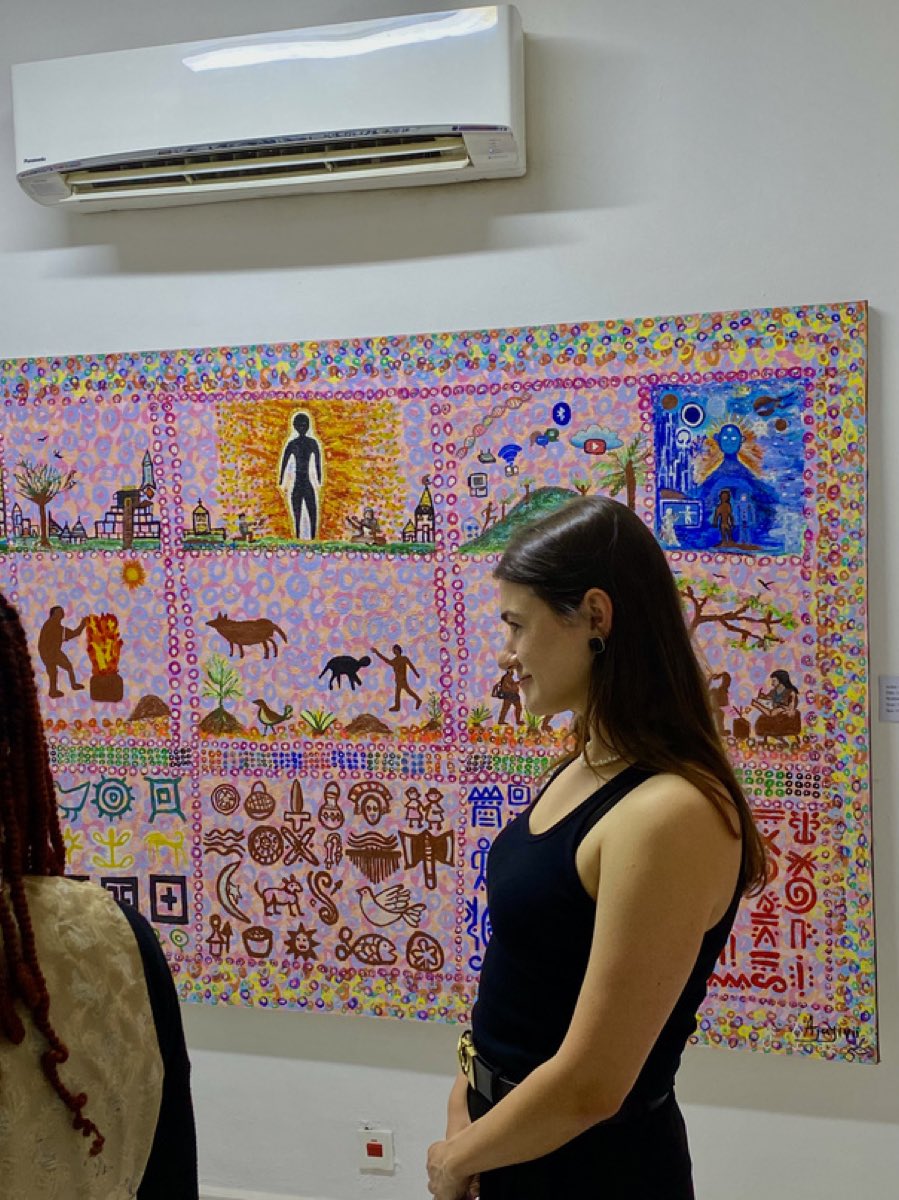 A visitor standing before Ìrìn Àjò Èdá àti Àṣà