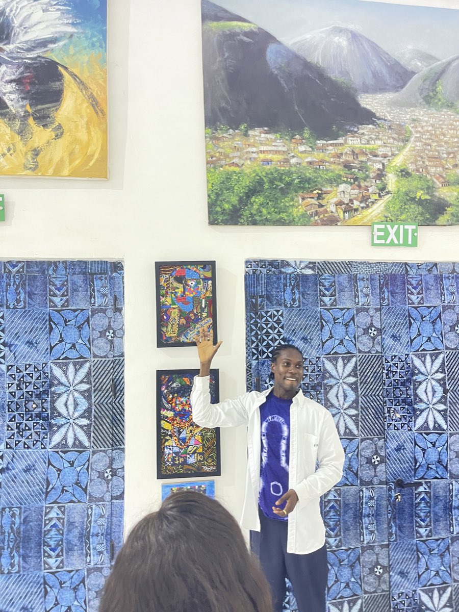 Visitors along the hung wall of the exhibition