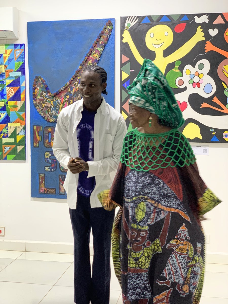 Chief Dr Nike Davies Okundaye at the opening of Ìpadàbọ̀, standing before the exhibited works